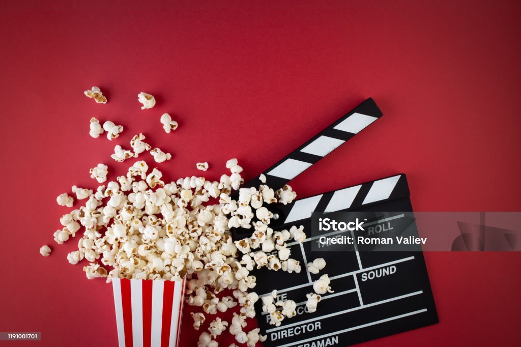 Popcorn with movie clapperboard — snack board for movie night