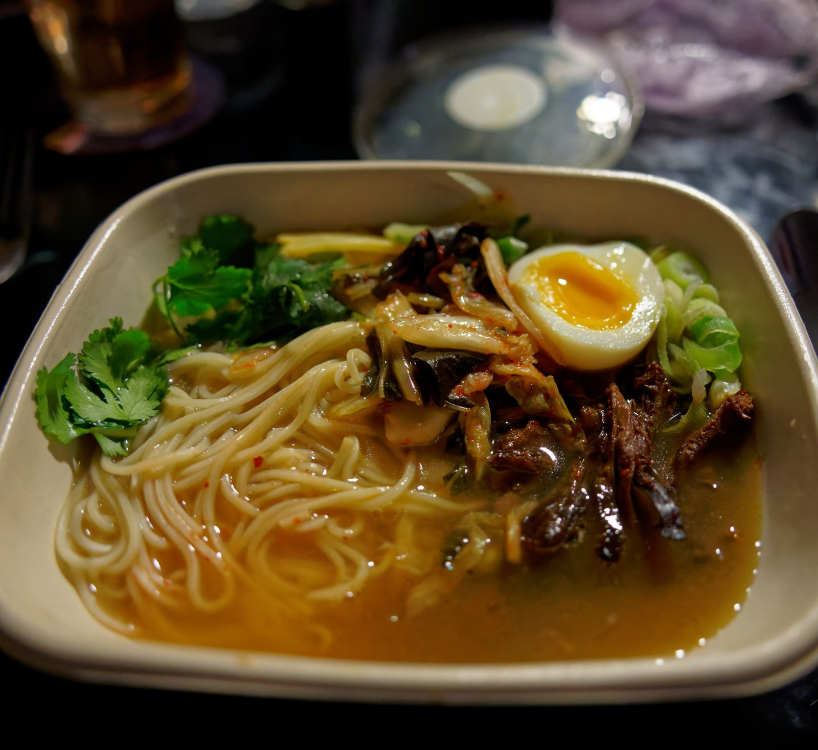 Close-up of a professionally prepared ramen bowl with rich broth and toppings
