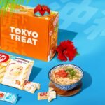 Official TokyoTreat box with Japanese snacks laid out around it