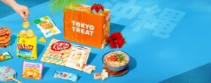 Official TokyoTreat box with Japanese snacks laid out around it