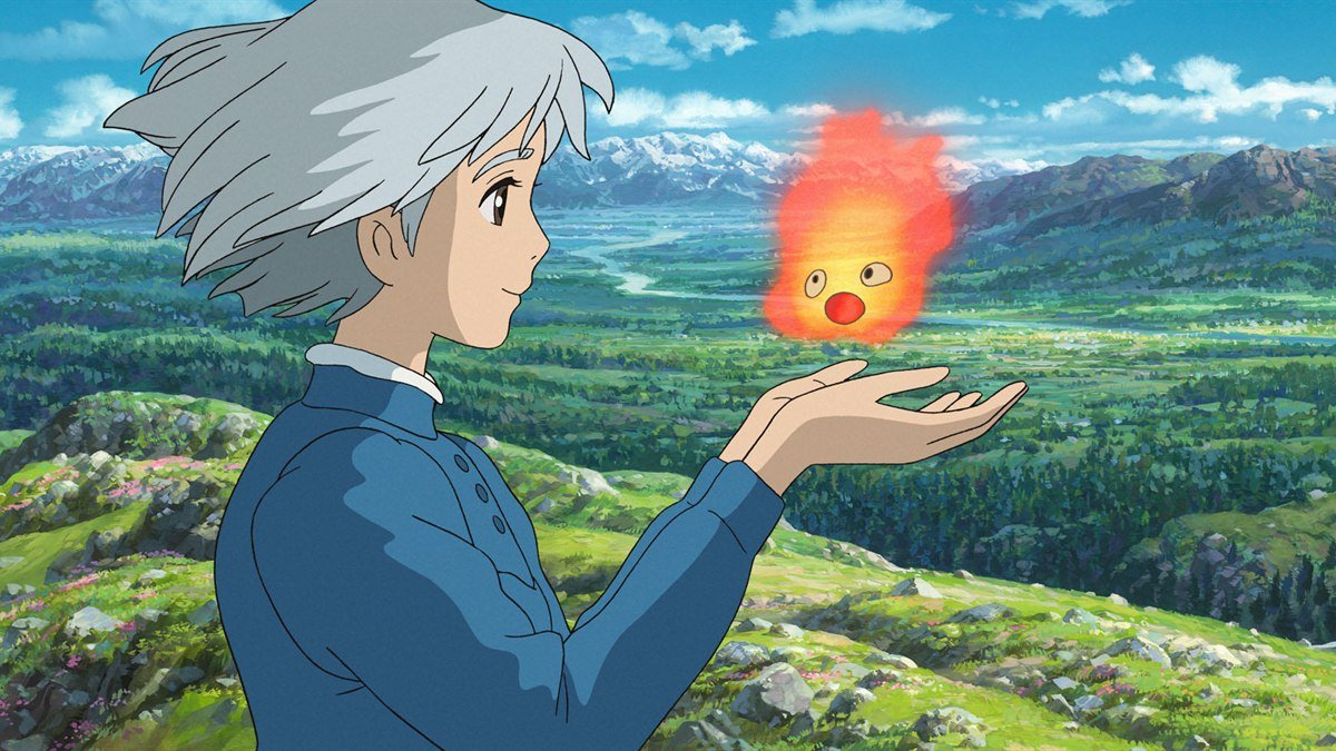Howl holding the fire demon Calcifer over a green valley in Howl’s Moving Castle