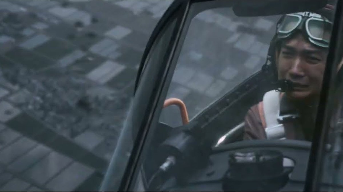 A pilot in goggles in a cockpit above the clouds in Godzilla Minus Zero